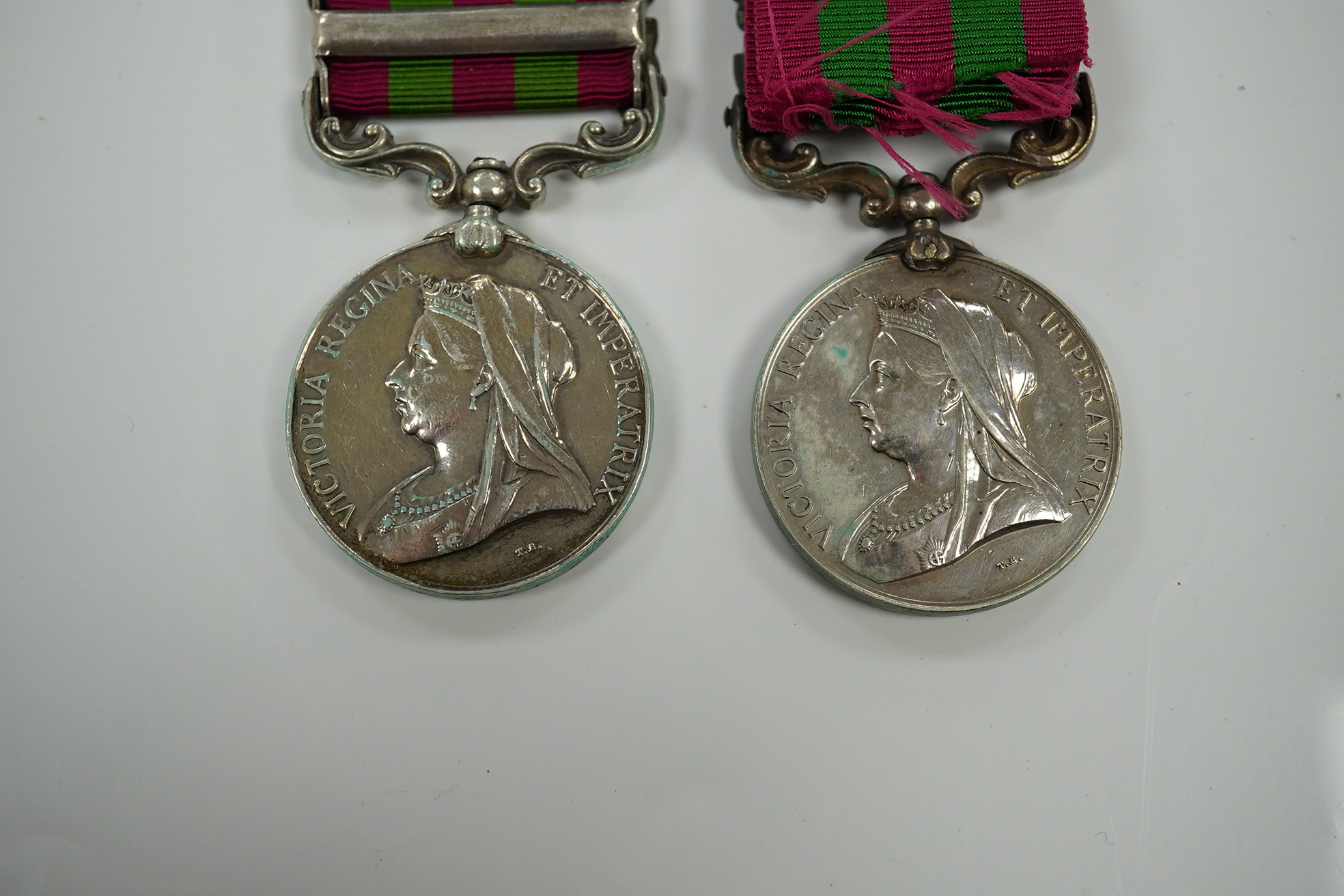 Two India Medals; one with Punjab Frontier 1897-98 and Relief of Chitral 1895 clasps, the other Tirah 1897-98 and Punjab Frontier 1897-98, both with naming erased.